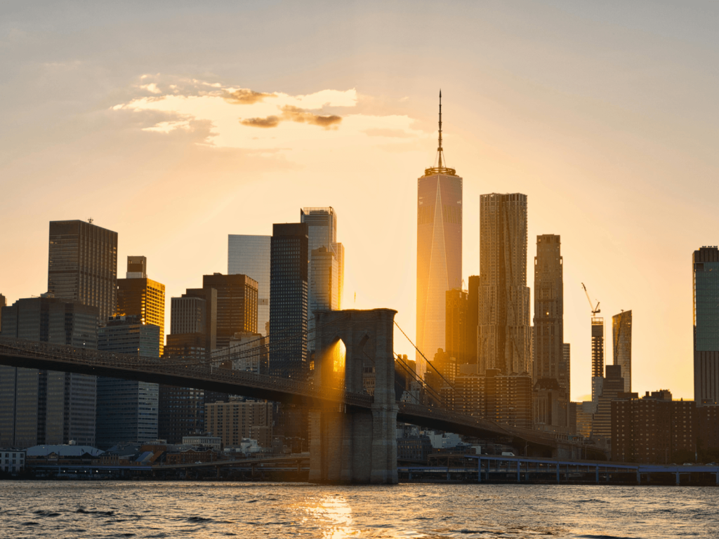 Brooklyn Bridge and the Lower Manhattan skyline glowing at sunset, perfect for Brooklyn Bridge captions.