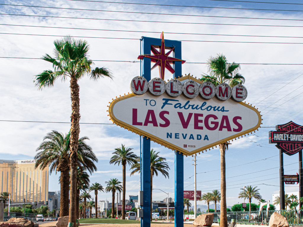 Famous Welcome to Fabulous Las Vegas Nevada sign surrounded by palm trees on a sunny day, perfect for Las Vegas captions.