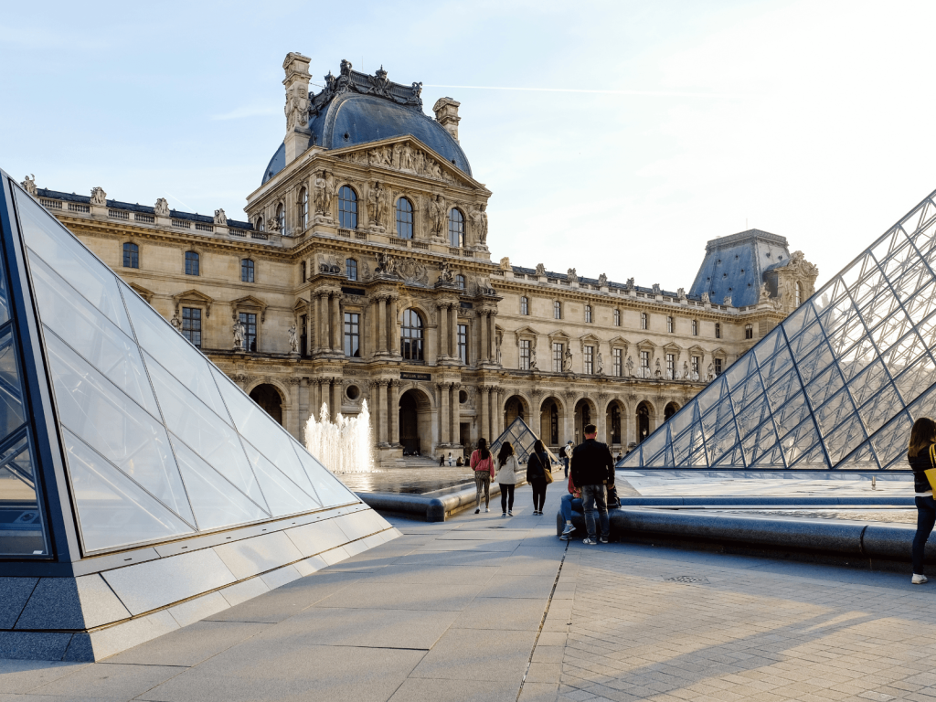 Louvre Museum and glass pyramids in Paris on a sunny day, perfect for a weekend in Paris itinerary