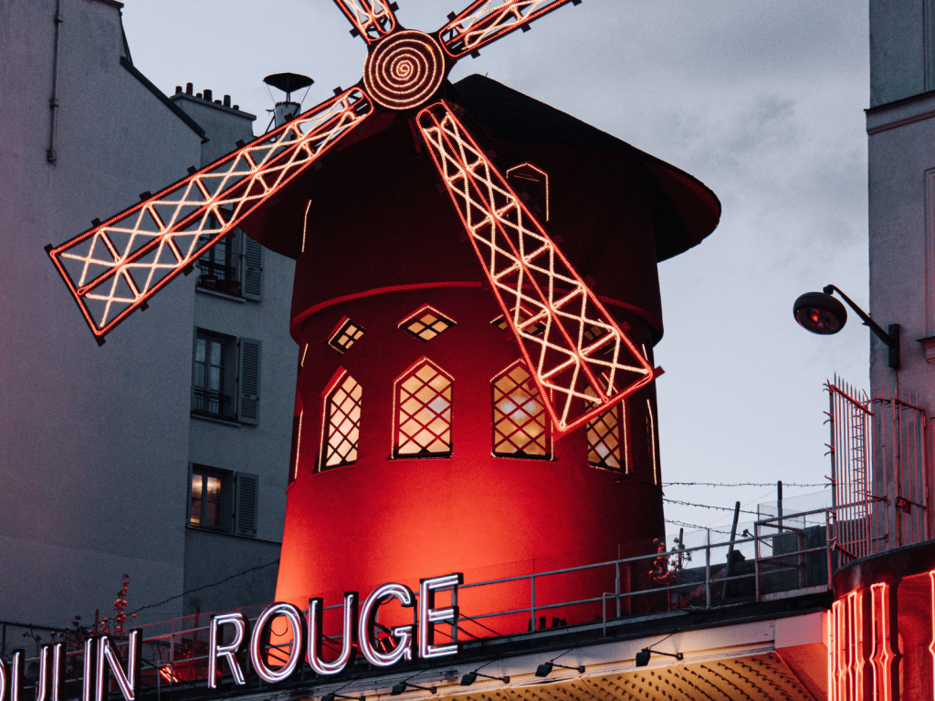 Illuminated red windmill at the Moulin Rouge in Montmartre, Paris.