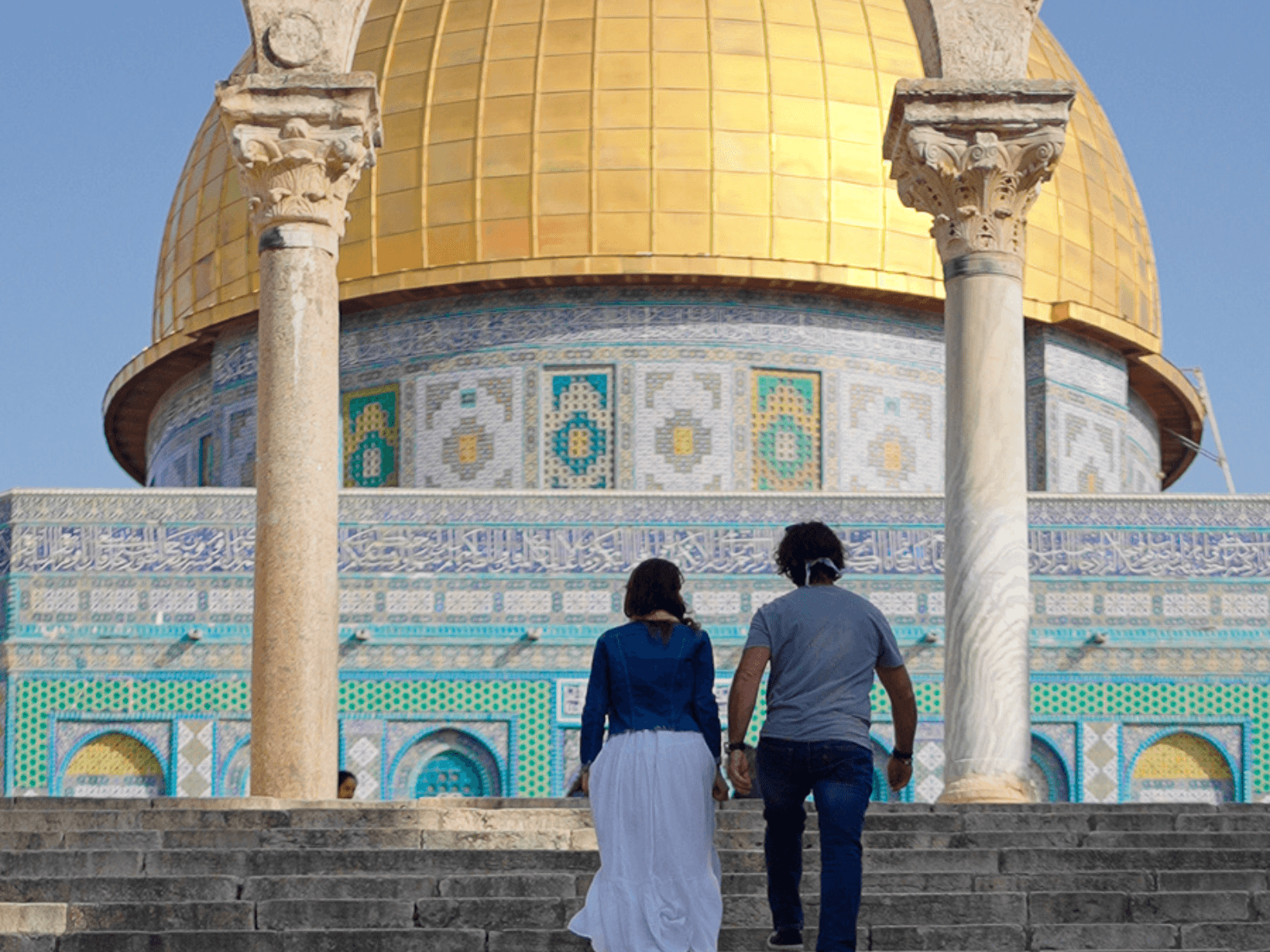Couple walking toward the golden Dome of the Rock in Jerusalem, a historic religious site featured in an itinerary for Israel.
