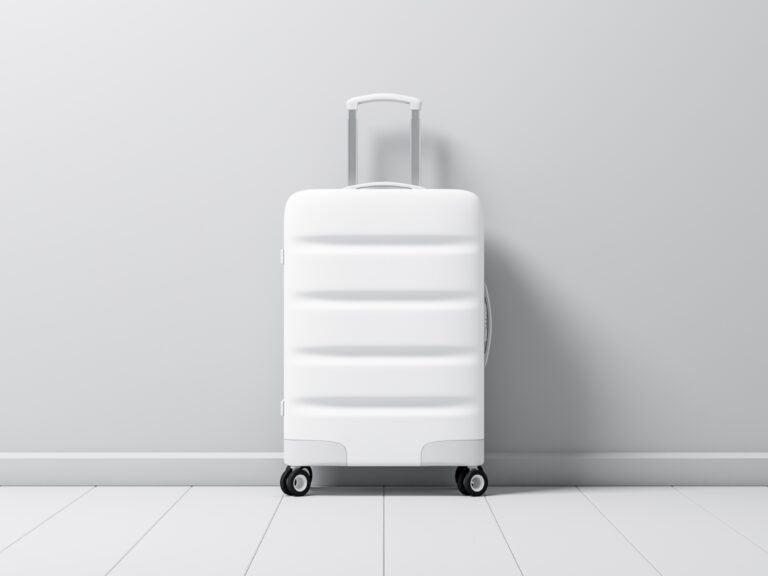 What to pack on a long flight photo of a white carry on suitcase.