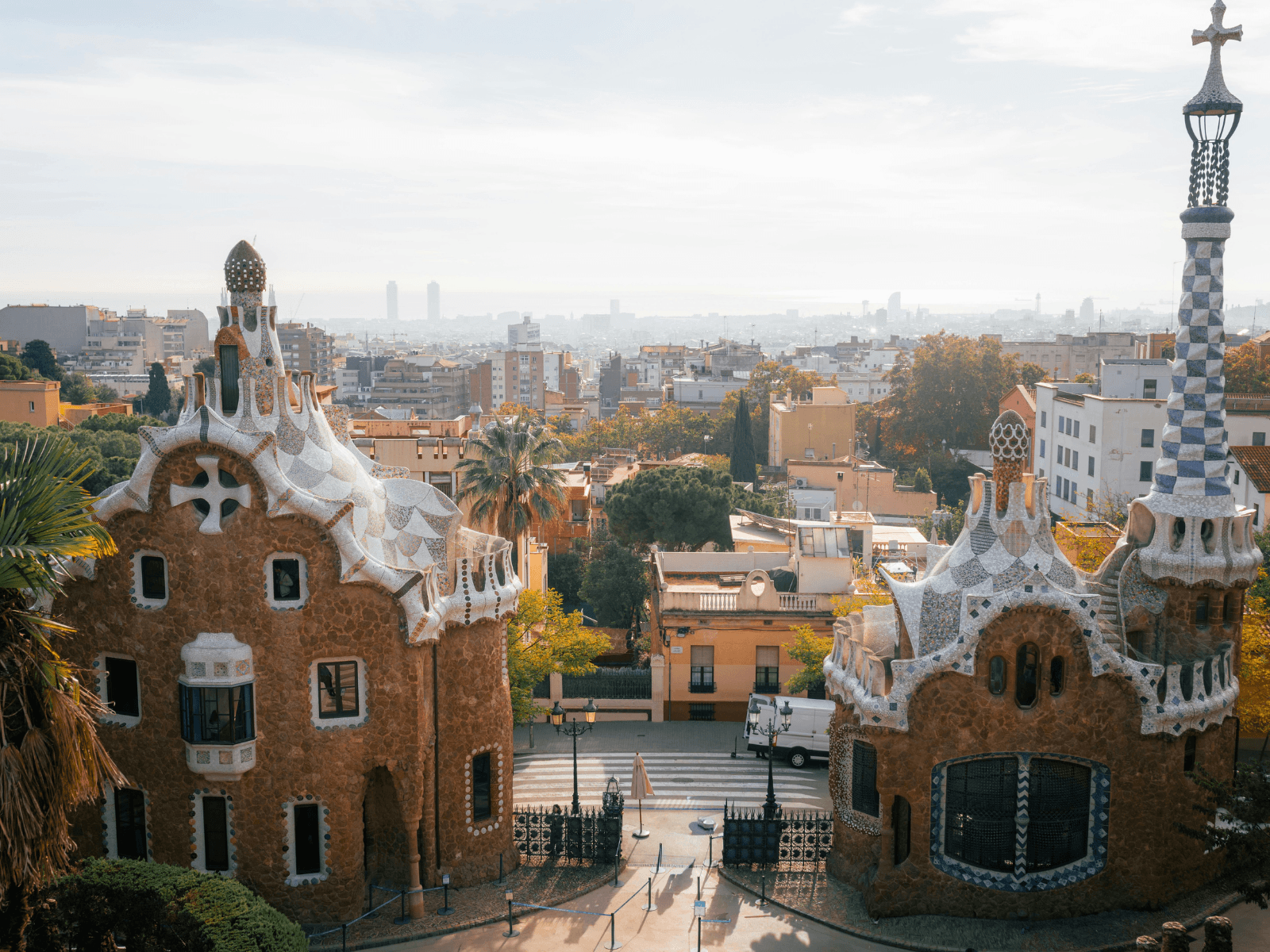 Colorful mosaic buildings and whimsical towers at Park Güell overlooking Barcelona, a scenic setting for Barcelona Instagram captions.