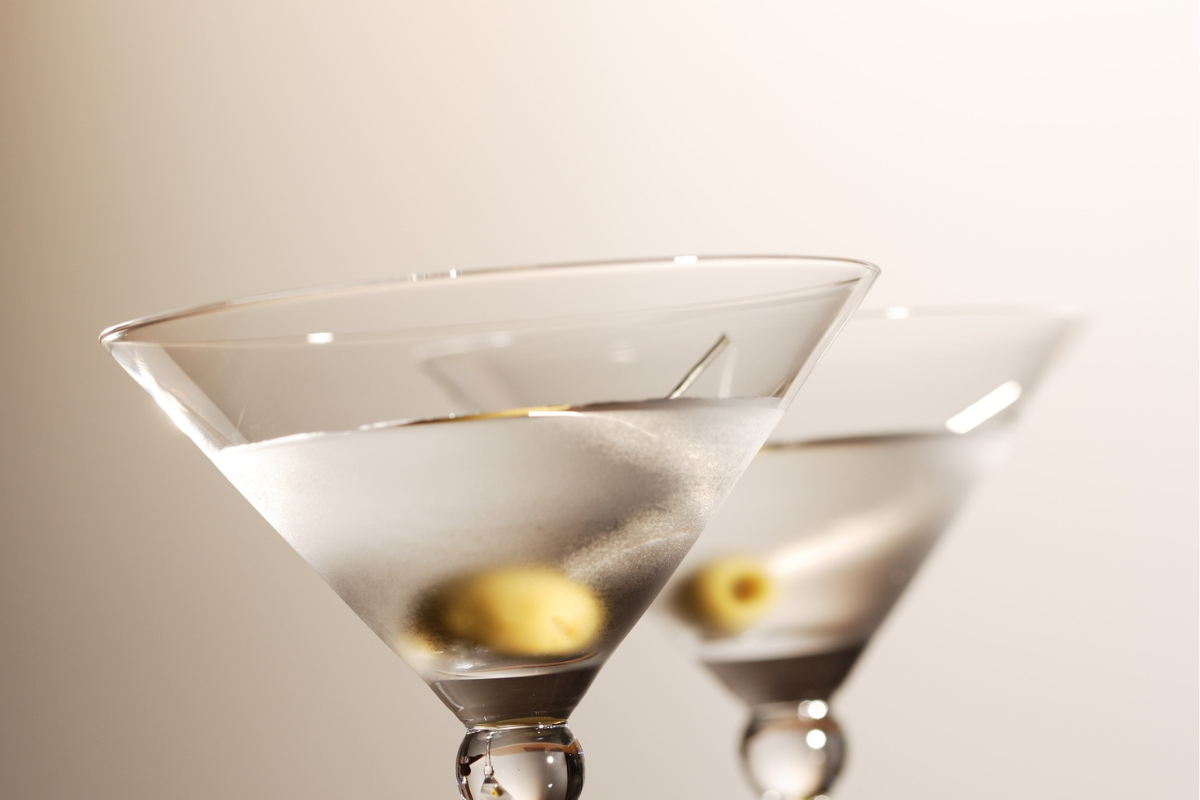 Two classic martini cocktails with green olives, perfect inspiration for cocktail captions on Instagram