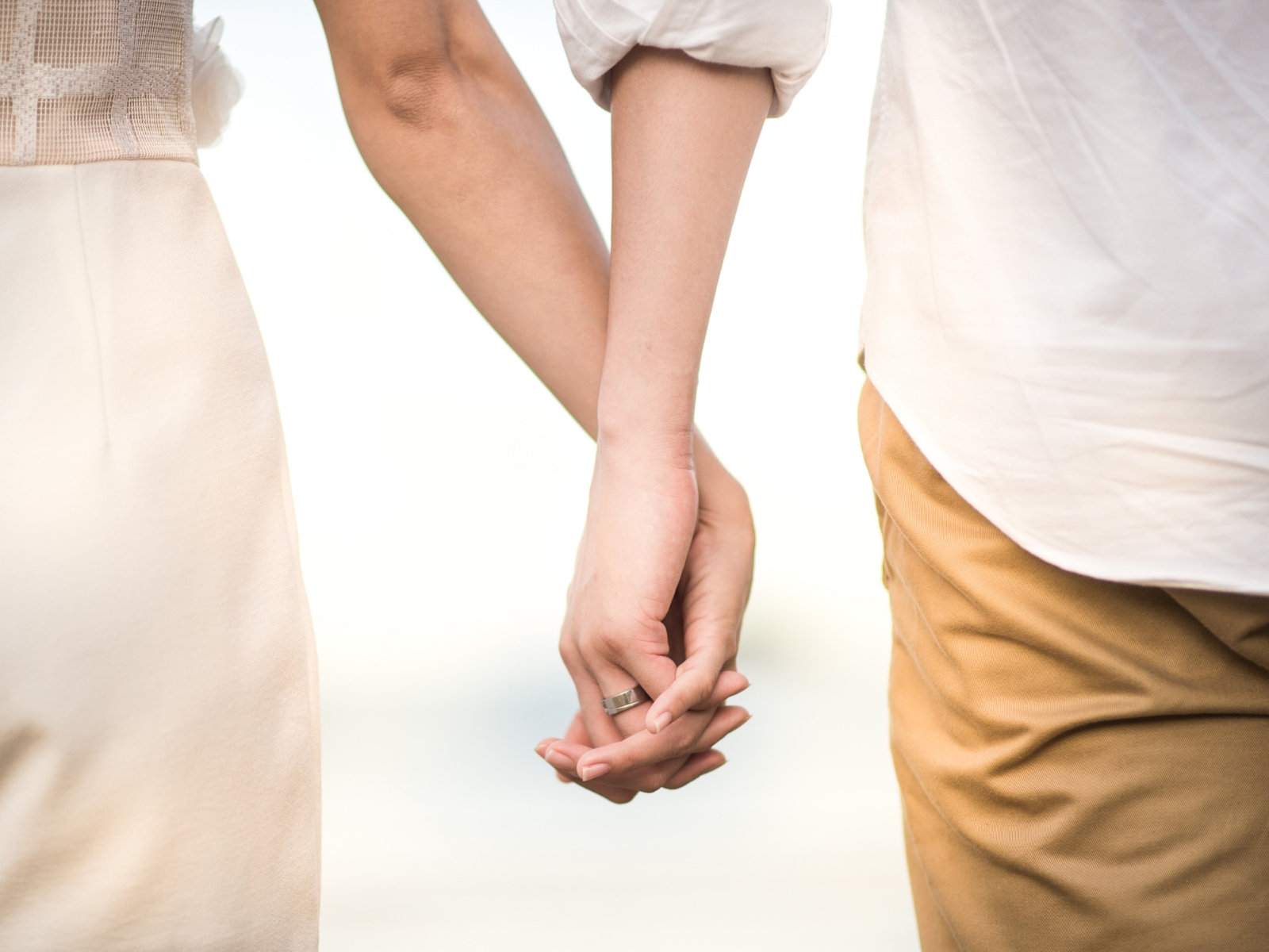 Two word captions for couples photo of a couple holding hands.
