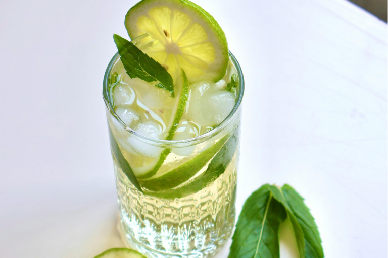 Refreshing lime and basil cocktail served over ice with fresh citrus and mint, perfect for basil cocktail recipes.