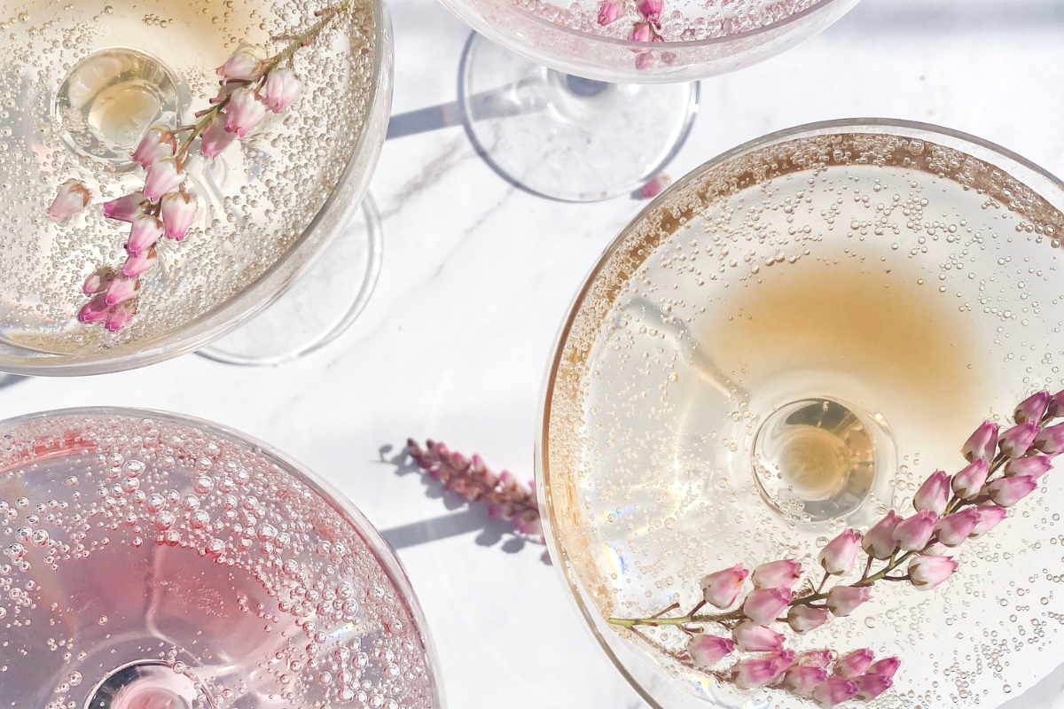 Sparkling pink and champagne cocktails garnished with delicate flowers, perfect inspiration for spring cocktail recipes.