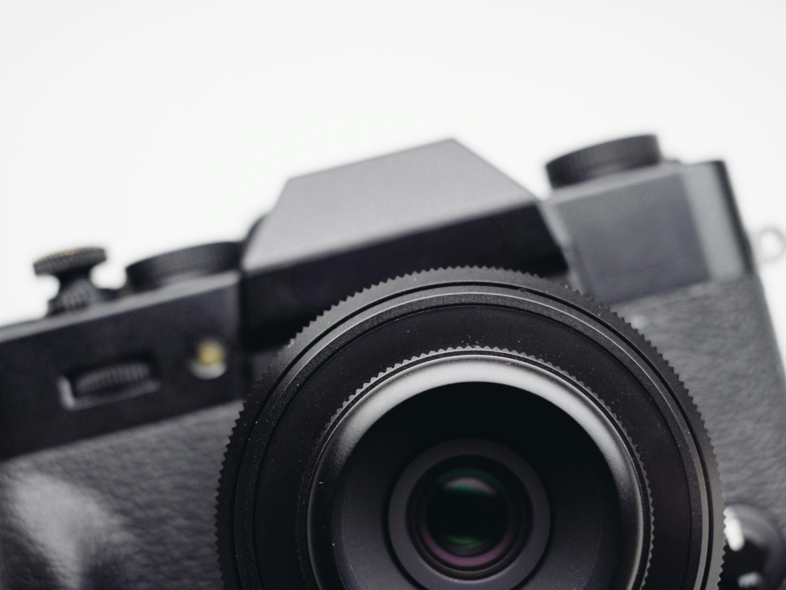 Close up of a black camera and large lens representing essential camera gear for photography.