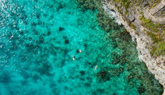 Aerial view of a beach in the Caribbean for one of the best Babymoon Destinations in the Caribbean.