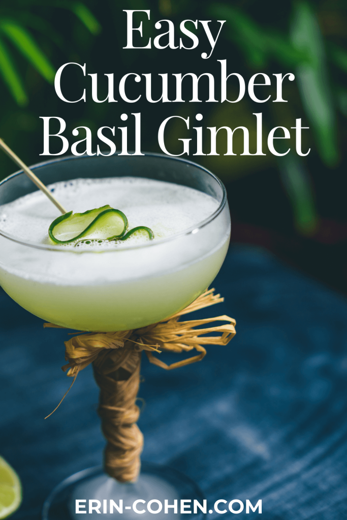 A vibrant easy cucumber basil gimlet cocktail served in a coupe glass, topped with cucumber ribbon garnish and a bamboo pick, with “Easy Cucumber Basil Gimlet” text above and lime wedges beside the glass on a deep blue surface.