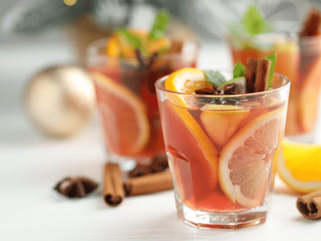 piced red sangria in short glasses with orange and grapefruit slices, cinnamon sticks, and star anise